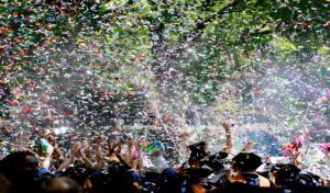 throwing graduation caps with confetti