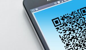 Phone with a QR code on a light blue background