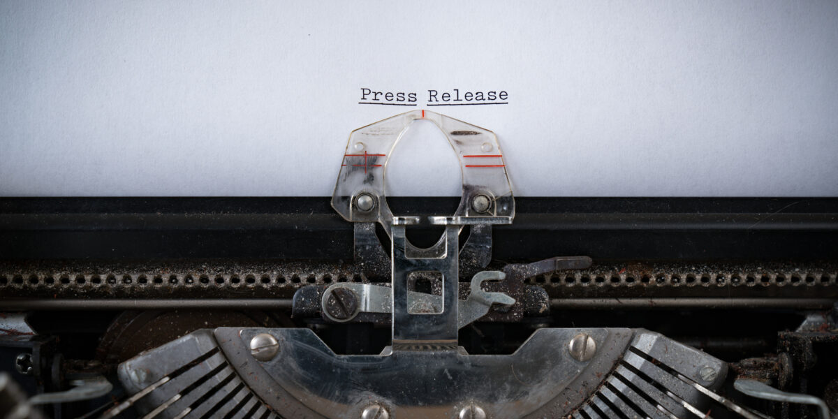 typewriter and the words "press release"