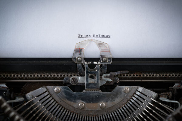 typewriter and the words "press release"