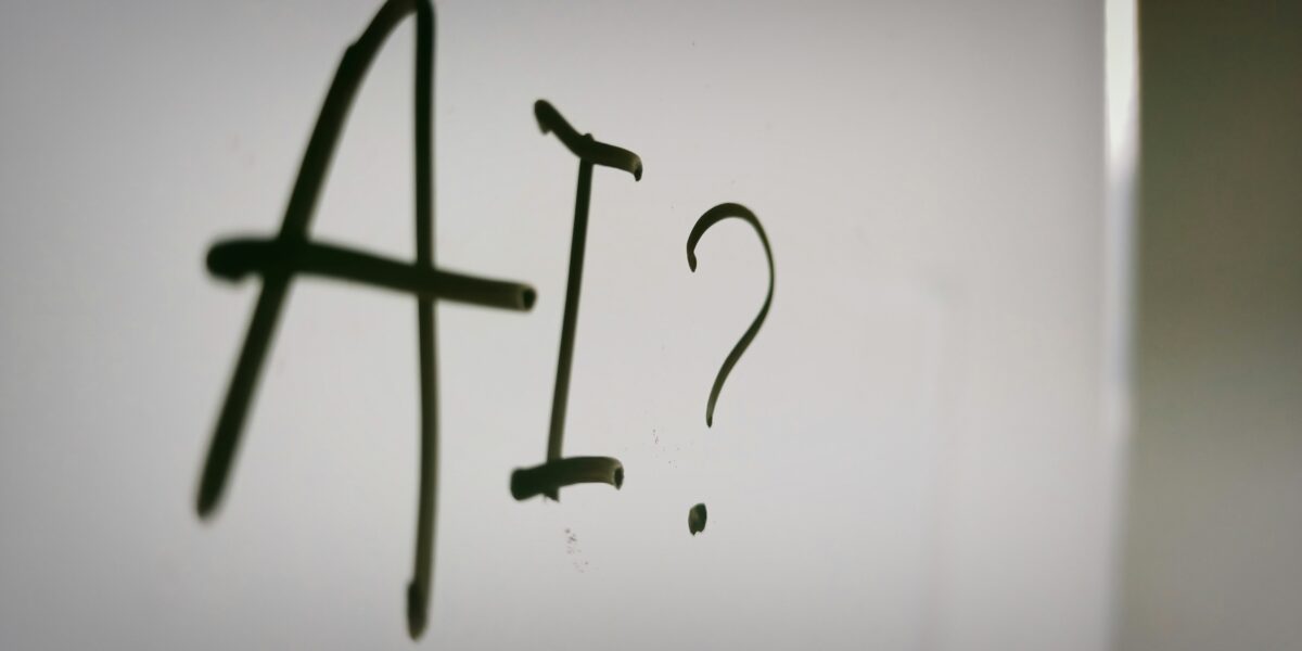 the words, "AI?" written on a whiteboard