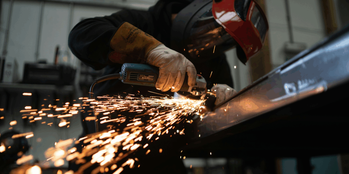 A welder welding in a manufacturing plant