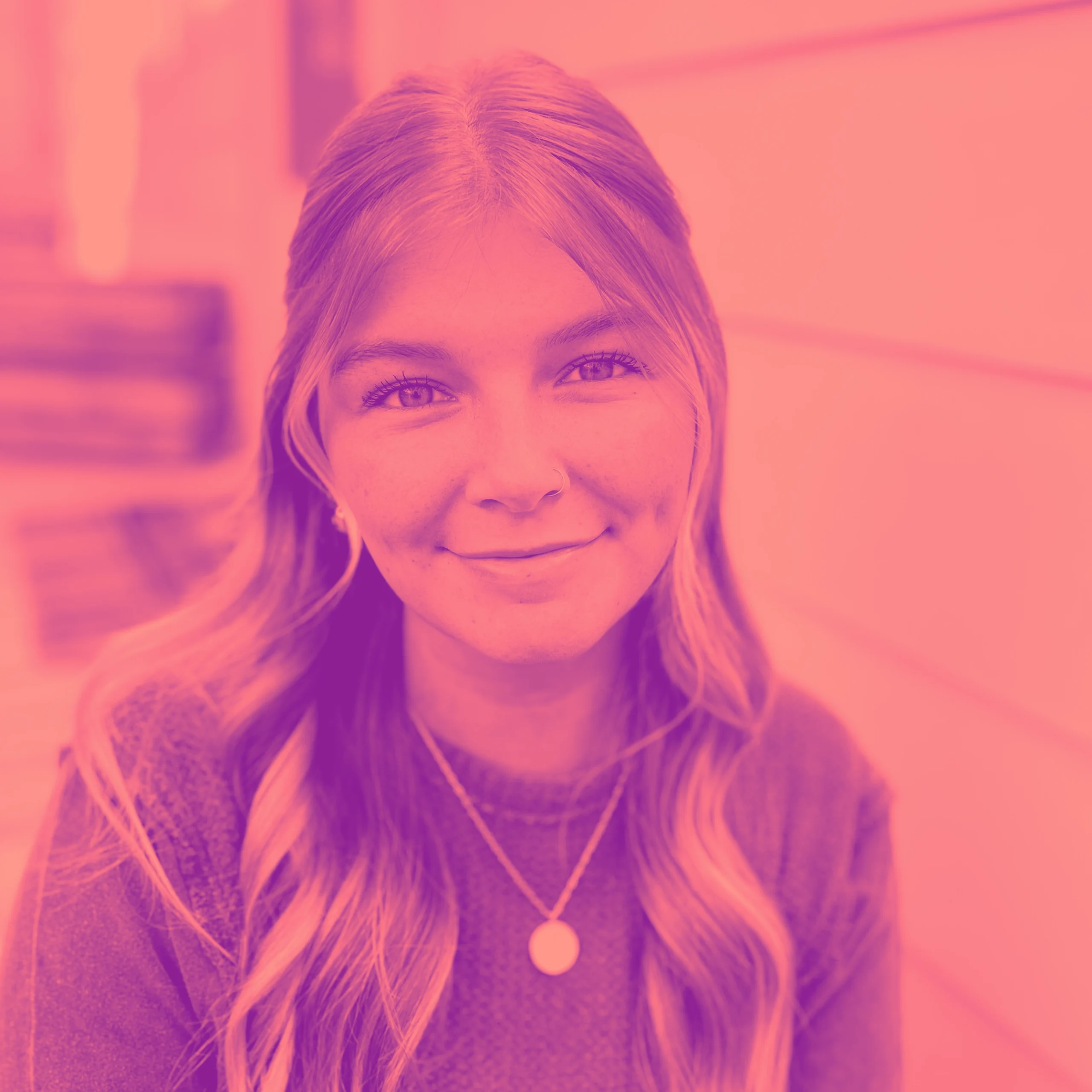 Katie_E_Duo Professional headshot of woman with wavy blonde hair and pink-magenta duotone treatment