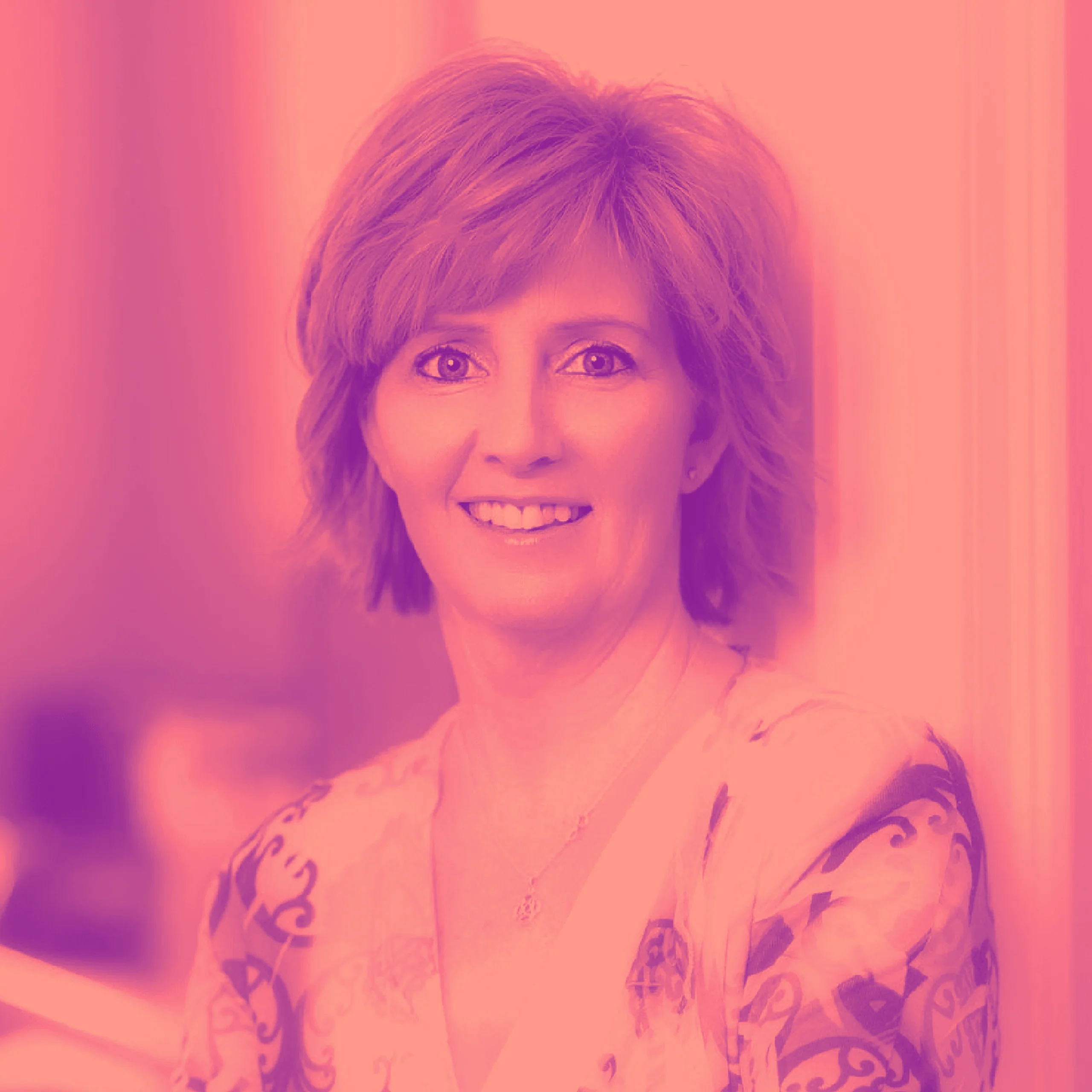Kelly_E_Duo Professional headshot of woman in patterned blouse with pink-magenta duotone treatment