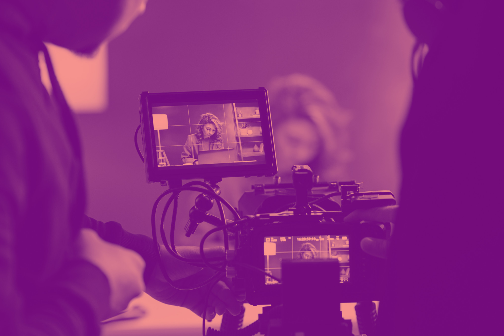 shutterstock_2198228653 Video production crew filming on set with deep purple duotone color treatment